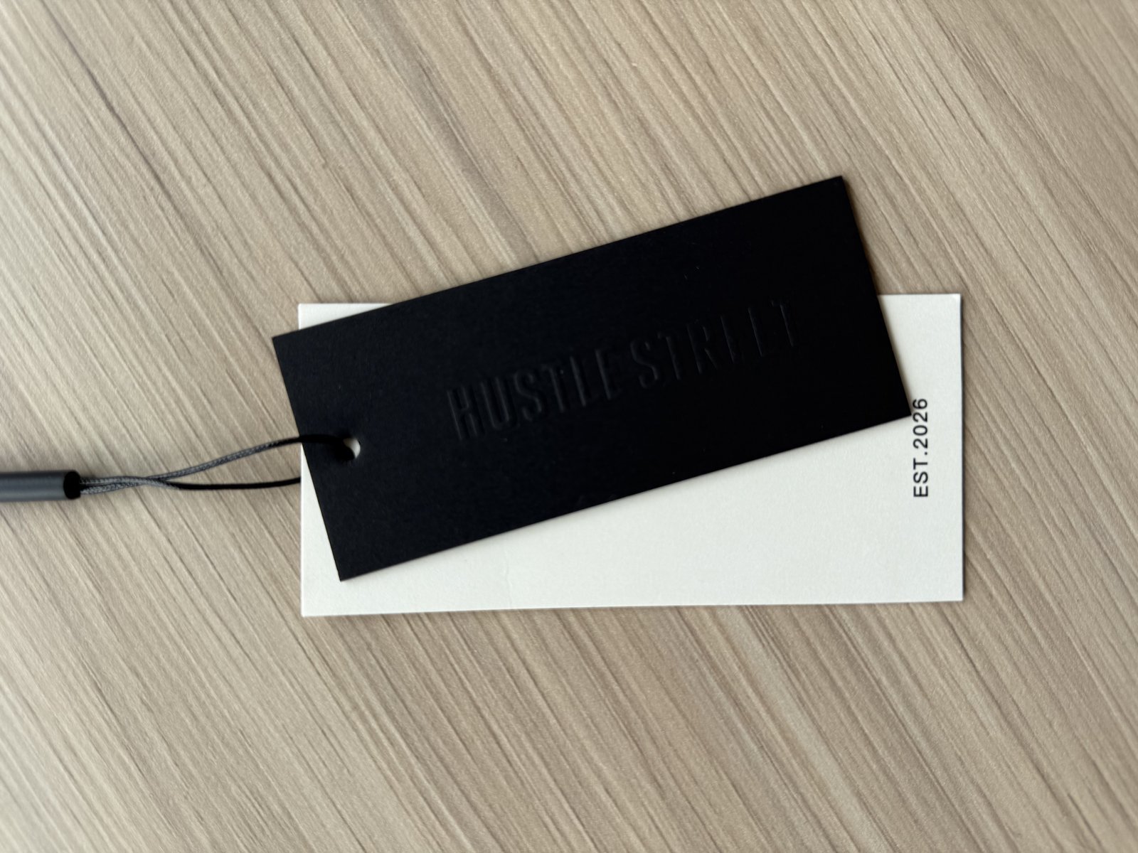 Cankun-produced black-and-white hang-tag sample set with string attachment