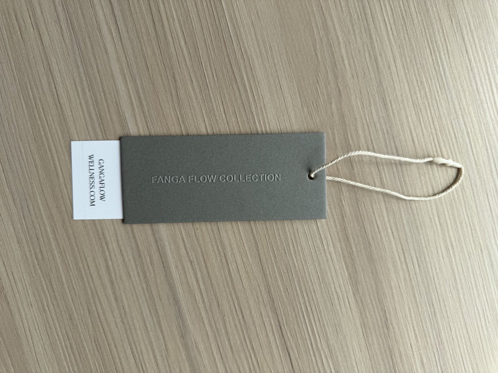 Cankun-produced gray hang-tag sample with white information area and string attachment