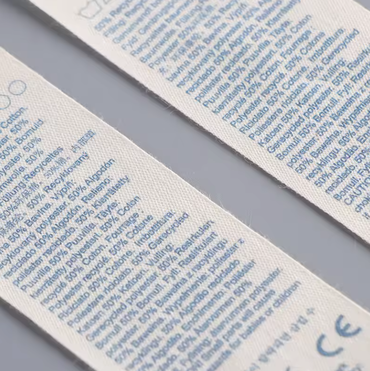 Close-up of blue text printed on cream care label samples